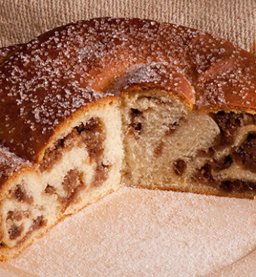 Gubana cake, a typical dessert from Valli del Natisone area. Posed on wooden plate and burlap.  Cividale del Friuli, Italy. October 2017