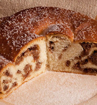 Gubana cake, a typical dessert from Valli del Natisone area. Posed on wooden plate and burlap.  Cividale del Friuli, Italy. October 2017