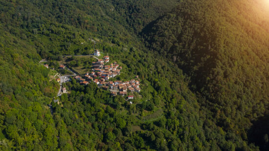 Beautiful small Italian village in mountains. aerial photo of the village of Topolò e municipality of Grimacco, in the province of Udine, region Friuli-Venezia Giulia north-eastern Italy. Small town